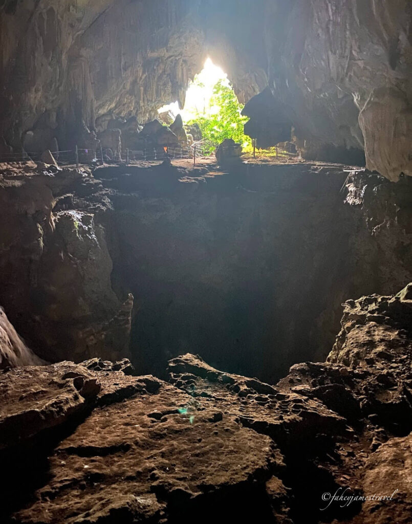 Secret Cave Vang Vieng. there is a big dark whole which leads to the end of the world. some light comes in the entrance of the cave