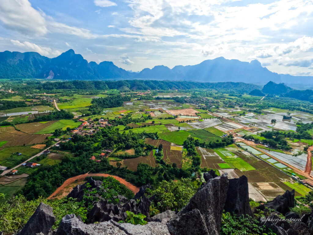 The view from the Nam Xay viewpoint looking down onto the rice fields in Vang Vieng. This is one of the best things to do in Vang Vieng