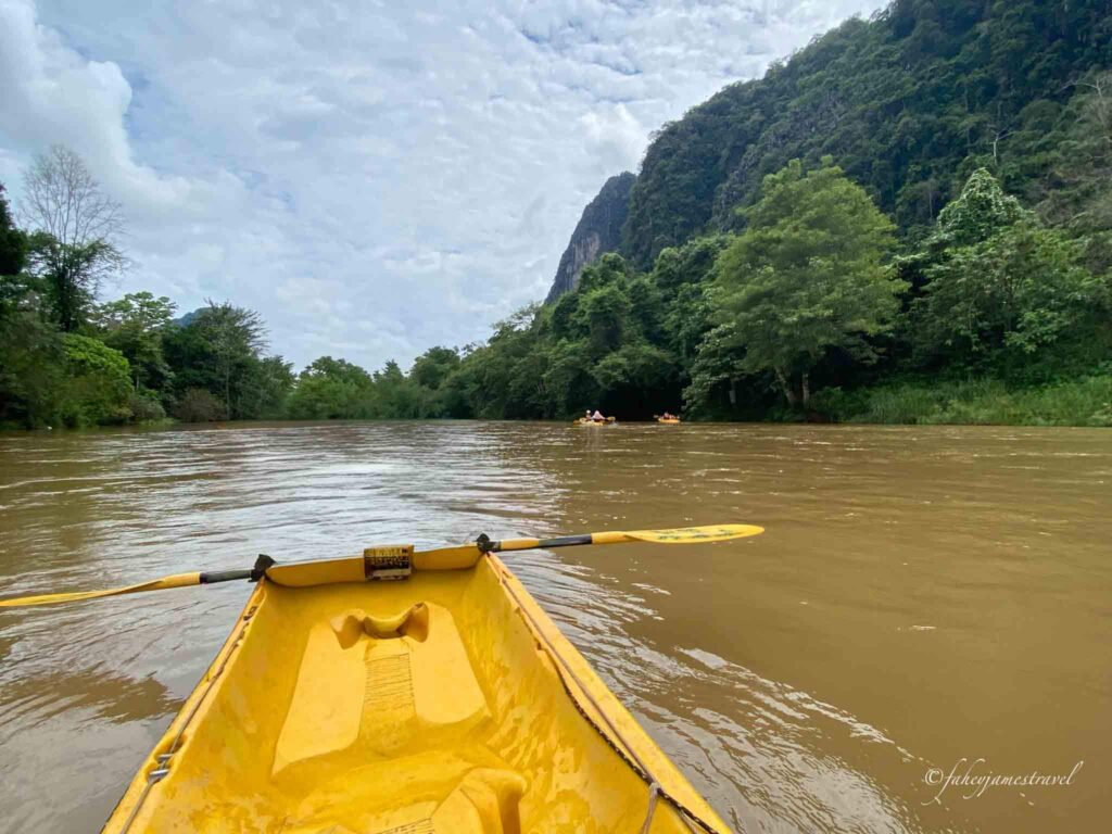 kayak is pictured on the river in vang vieng and is one of the best things to do