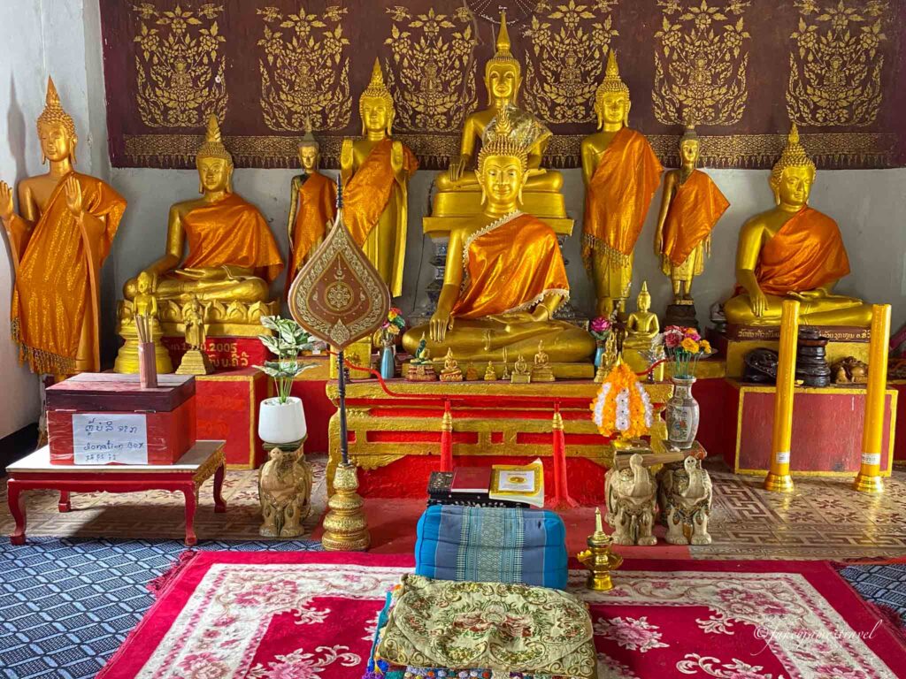Vat Syrimoungkoun Xaiyaram is pictured with golden buddhas
