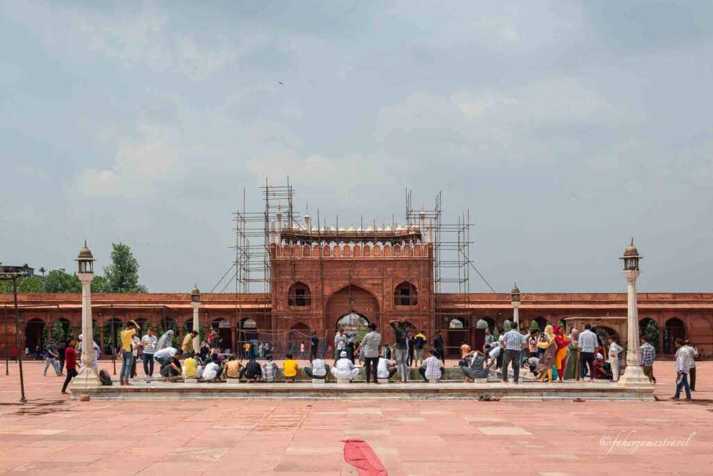 people sit down isnide jama masjid in delhi during my 3 day trip