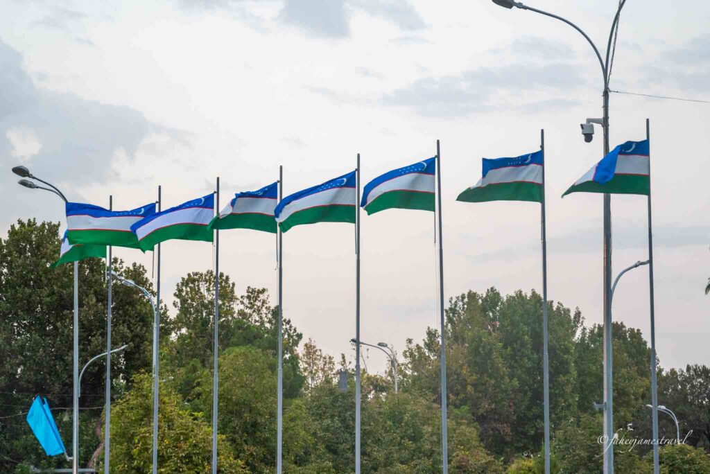 uzbek flags are pictured on many poles in samarkand