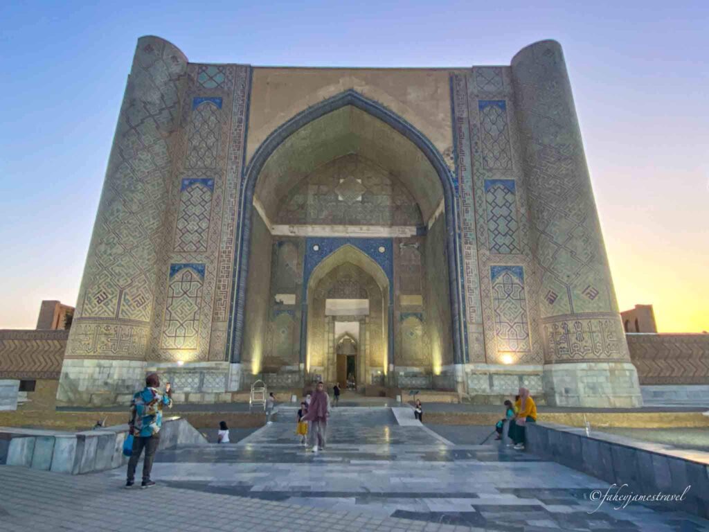 Bibi-Khanym Mosque is pictured at sunset with peole walking around and is one of the unique things to do in samarkand