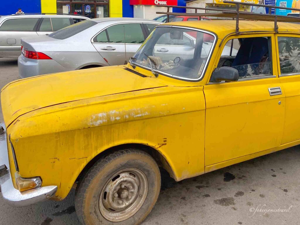yellow taxi is pictured from bishkek to karakol
