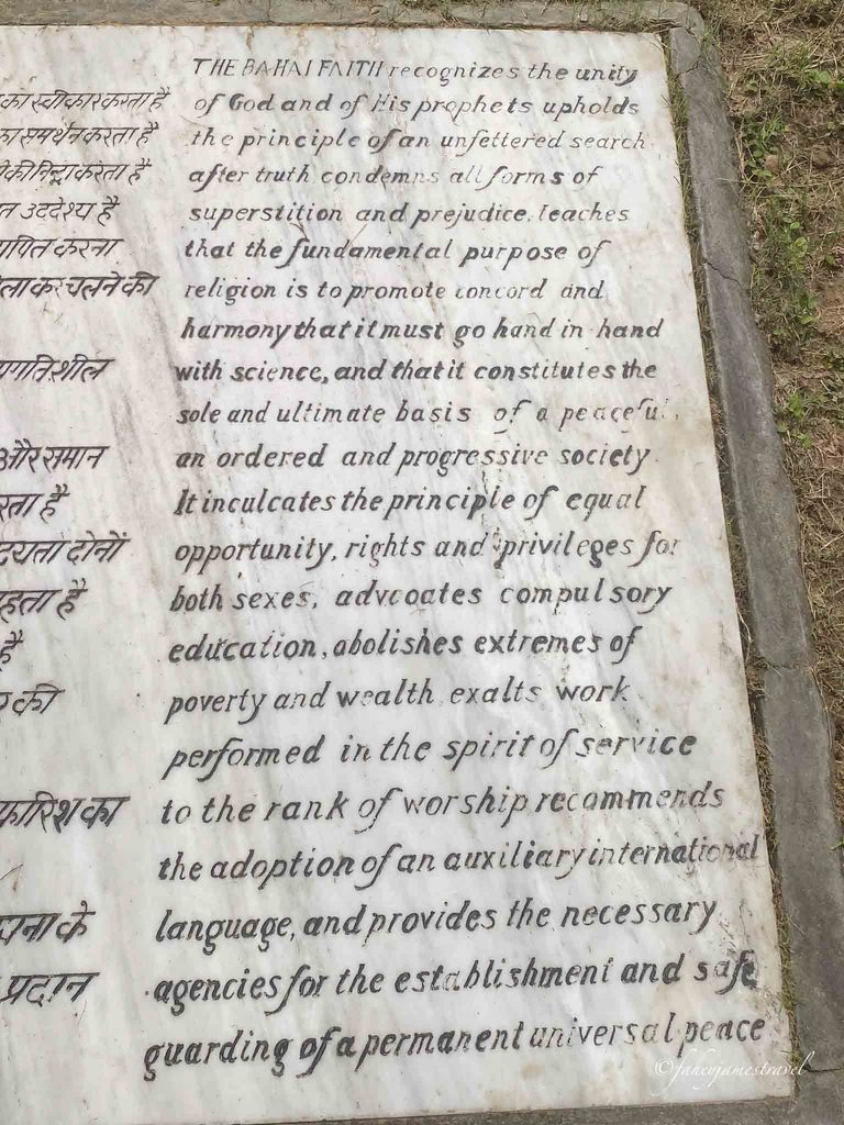 Baha'i faith lotus temple plaque that describes the faith. Lotus Temple is nearest metro station