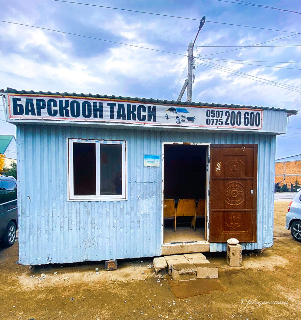 the taxi rank in barskoon wherew we booked a taxi to the waterfall. the taxi rank is blue and the door is open