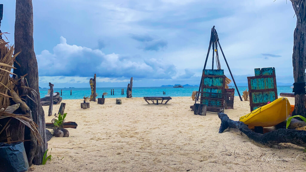 the view of. thesea from Zodiac beach bar on koh lipe. the sand is white and sift and there are some clouds in the sky