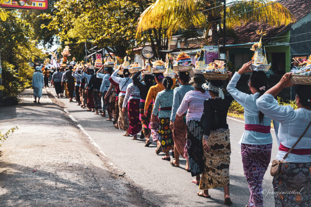 women march through the streets of amed bali with bags on their head