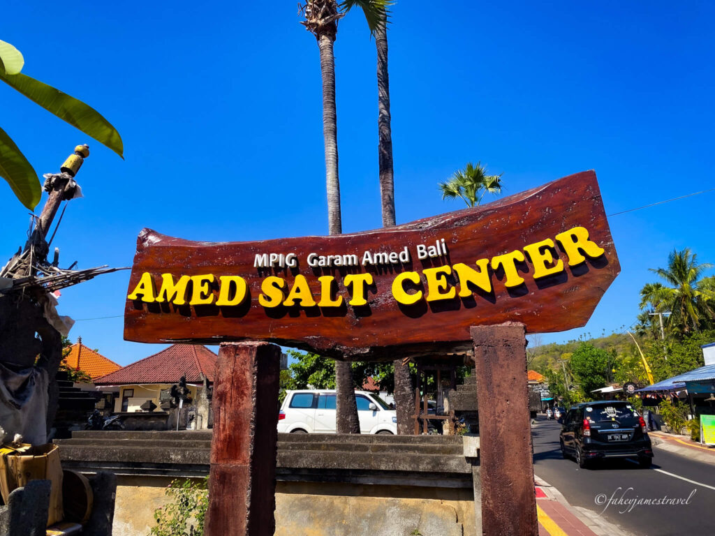 a big yellow and brown sign that reads amed salt centre. the palms trees can be seen at the background 
