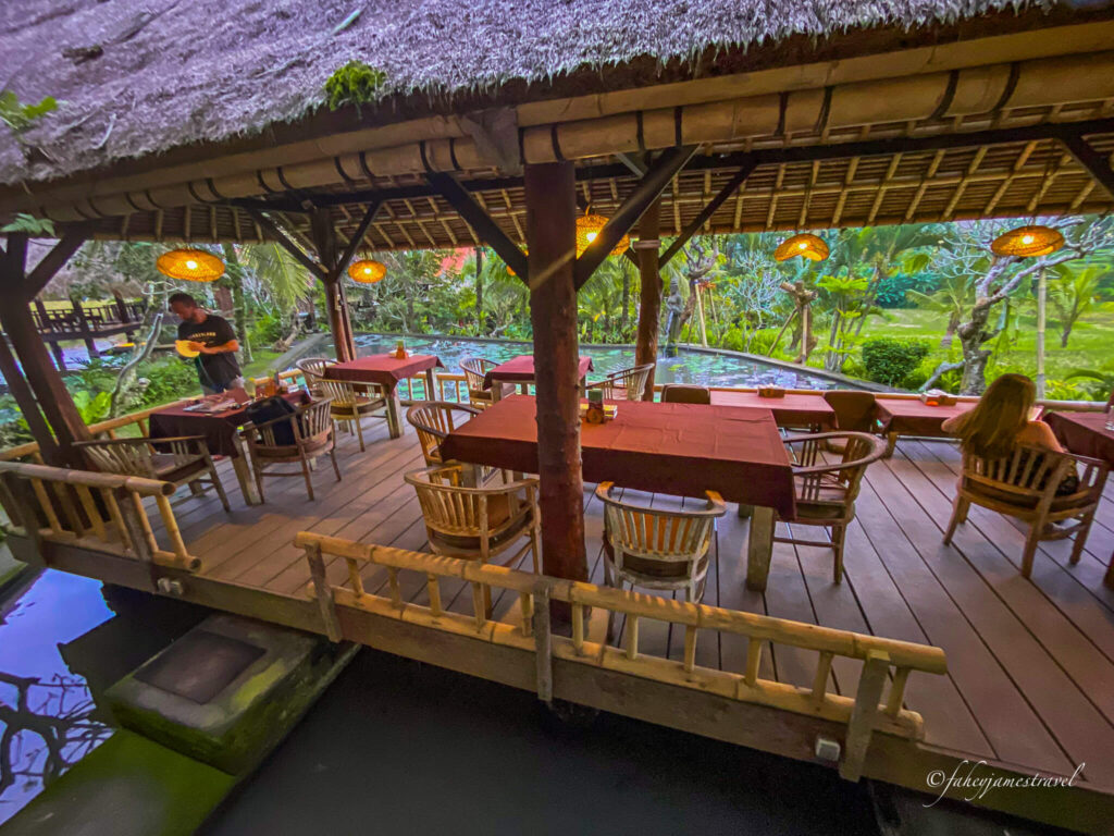 a restaurant and seating area sit covered with a red table cloth and wooden surrounding 
