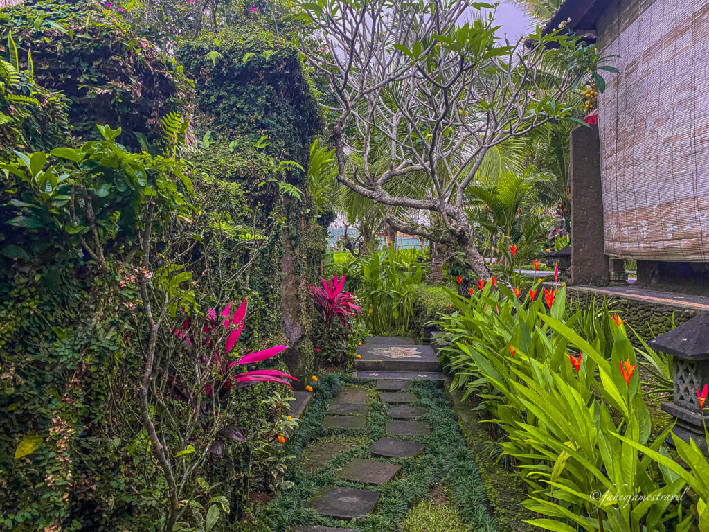 flowers line the narrow walkways to some hotel in ubud 