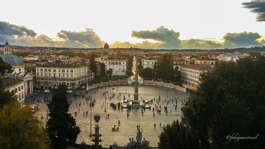 Piazza del Popolo is visible from the terrace above the square. the clouds fill the sky 