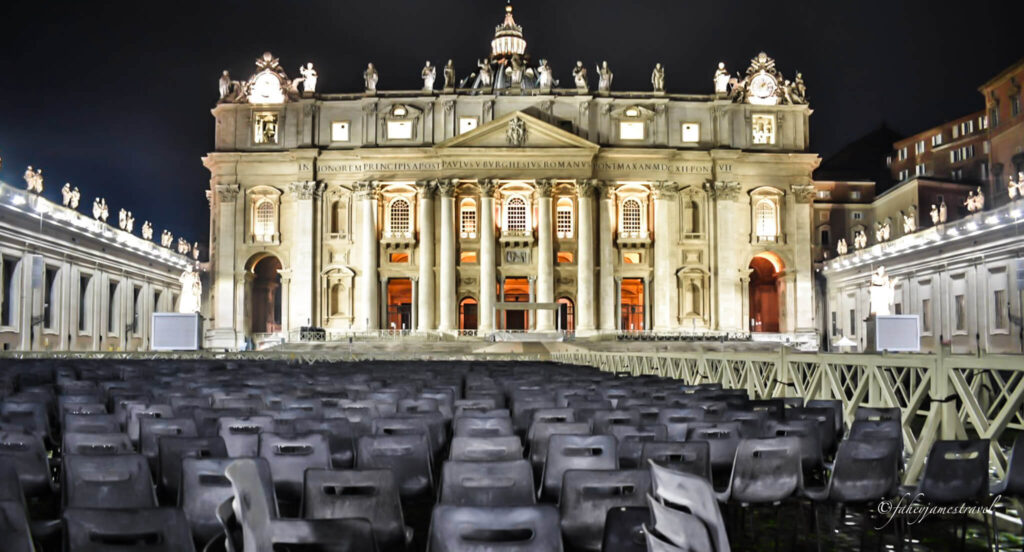 chairs sit in front of the vatican at night time