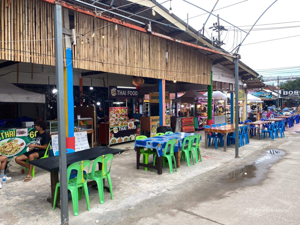 green small seats are left undisturbed inside koh lanta night market just before it started to get busy. it is daytime