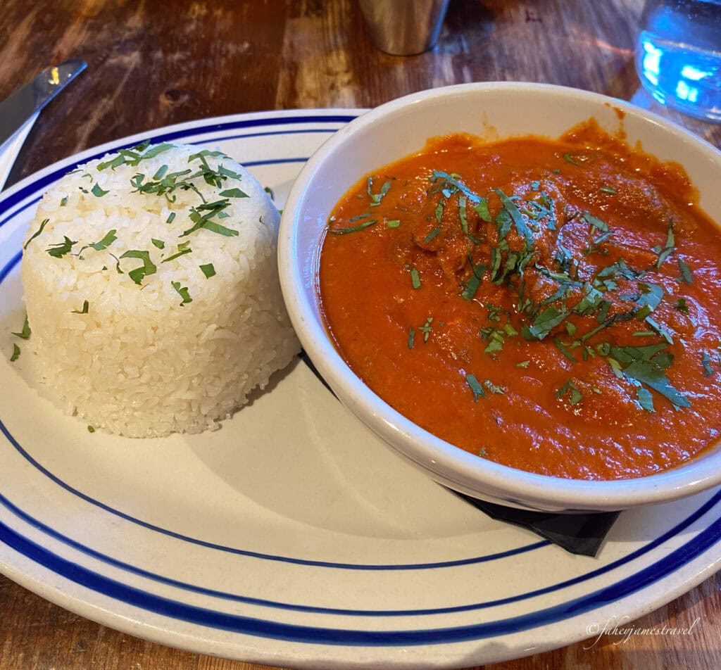 indian curry is shown with red sauce and rice in the Western market, Dukes grocery