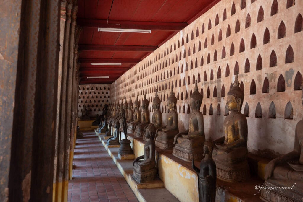 many buddha statues are shown inside a temple in vientiane