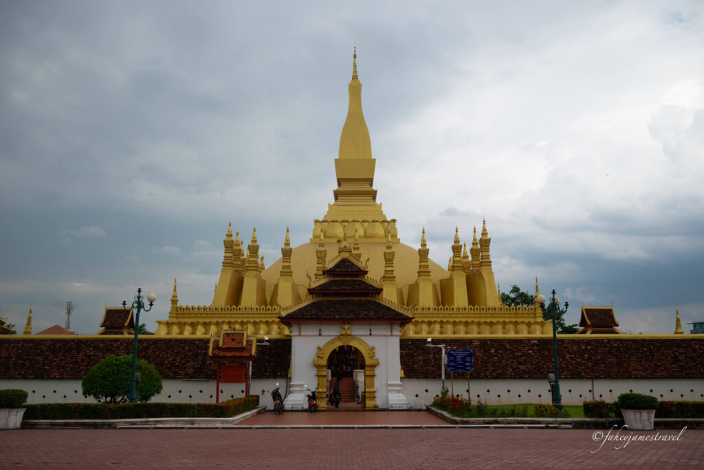 Pha That Luang is shown from the outside with the wall and entrance in the centre of the screen