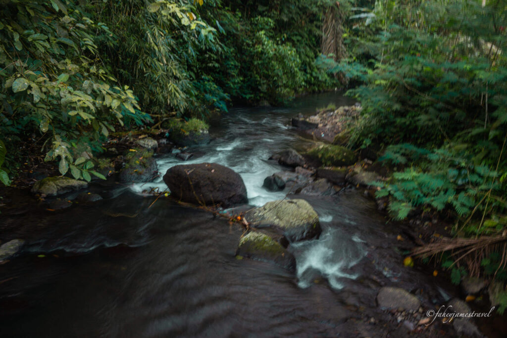 a river is shown close to leke leke waterfall on the way to the hike