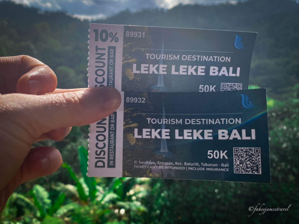 james holds a ticket into leke leke waterfall and the price is shown at 50,000