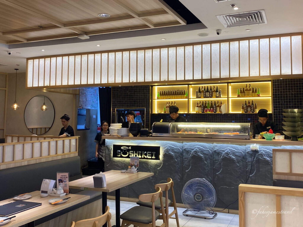 staff work behind the counter at Sushi Kei Vincom Royal City some of hanois best sushi
