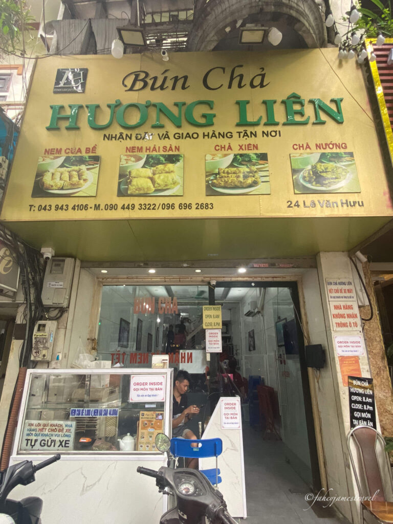 Bún Chả Hương Liên is pictured at the entrance with a man at the door