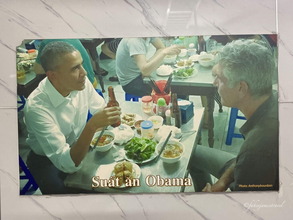 obama and bourdain are pictured siittng inside the restaurant 