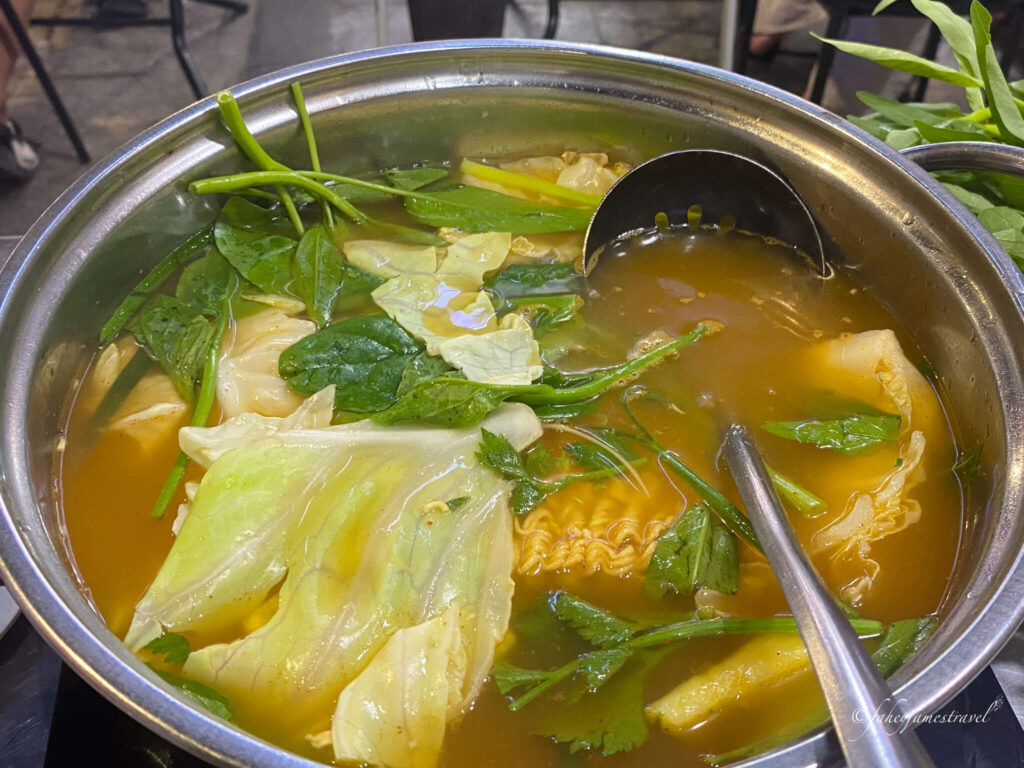 hot pot is a nice thing to eat in hanoi with fresh seafood and herbs and lettuce
