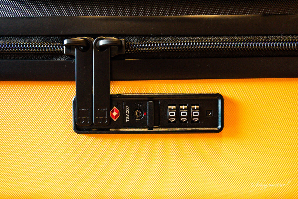 TSA LOCK IS PICTURED ON JAMES LEVEL8 LUGGAGE REVIEW WITH CLOSE UP on the lock