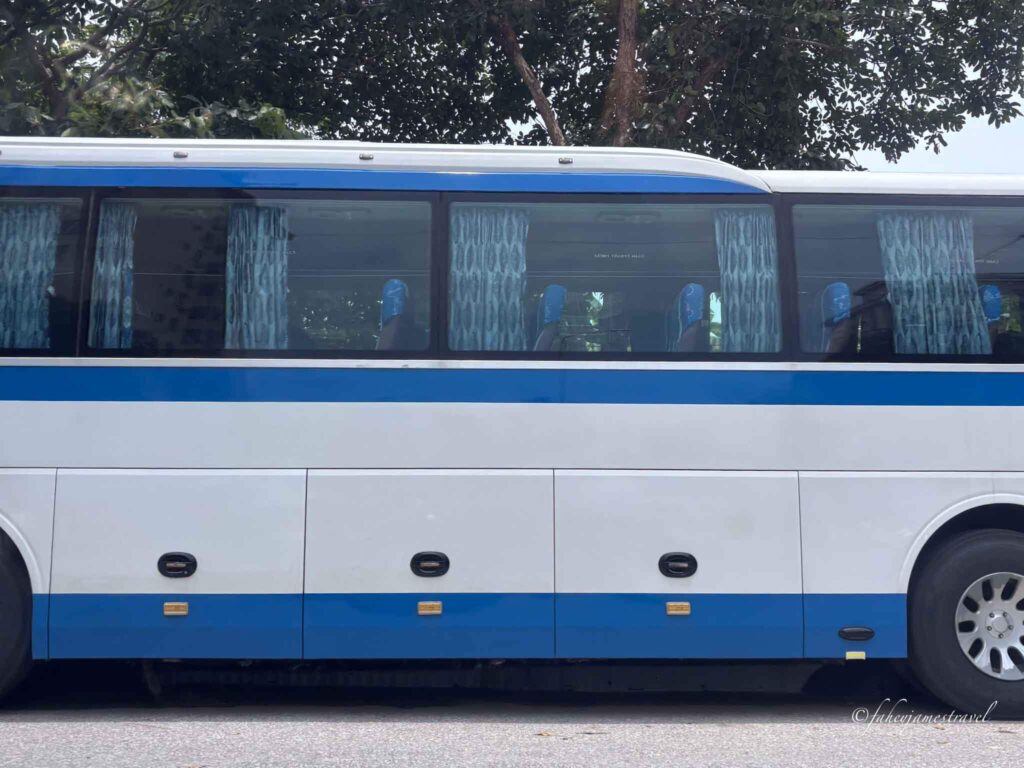 blue and white bus is pictured from hanoi airport to halong bay