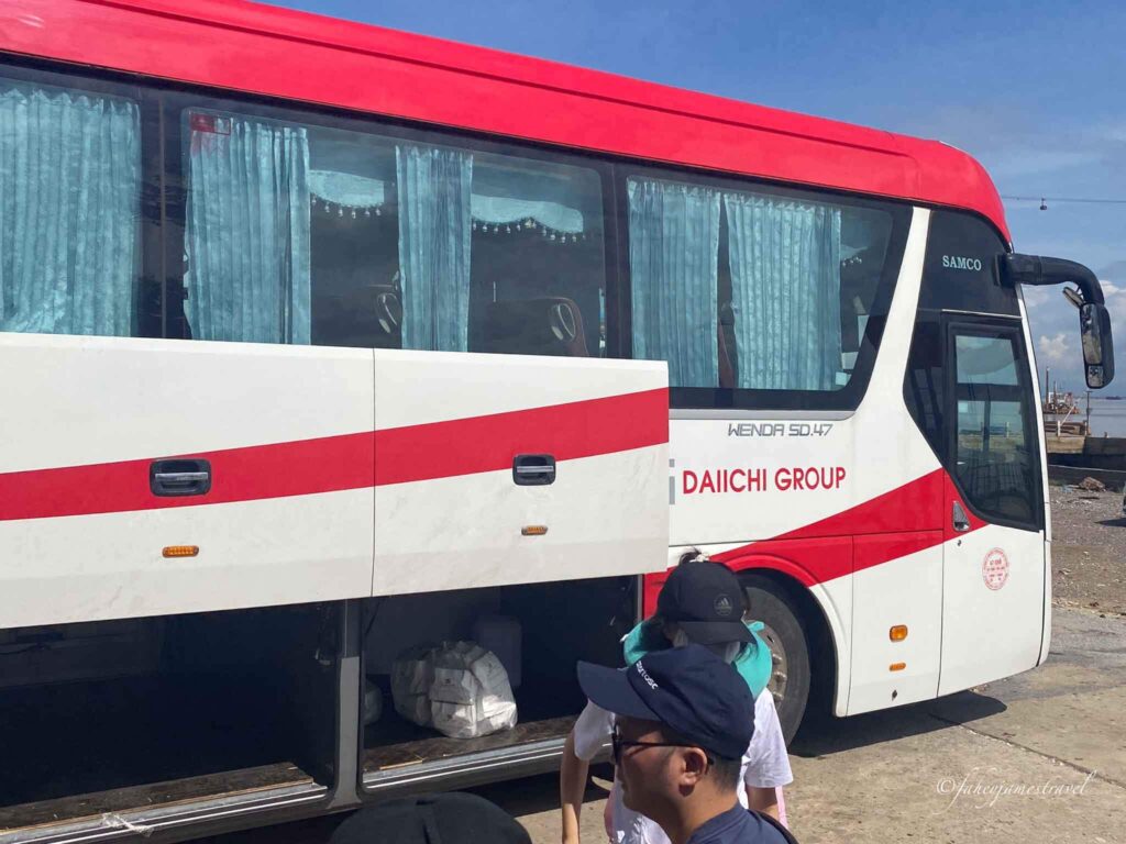 red and white bus from hanoi to ha long bay is pictured