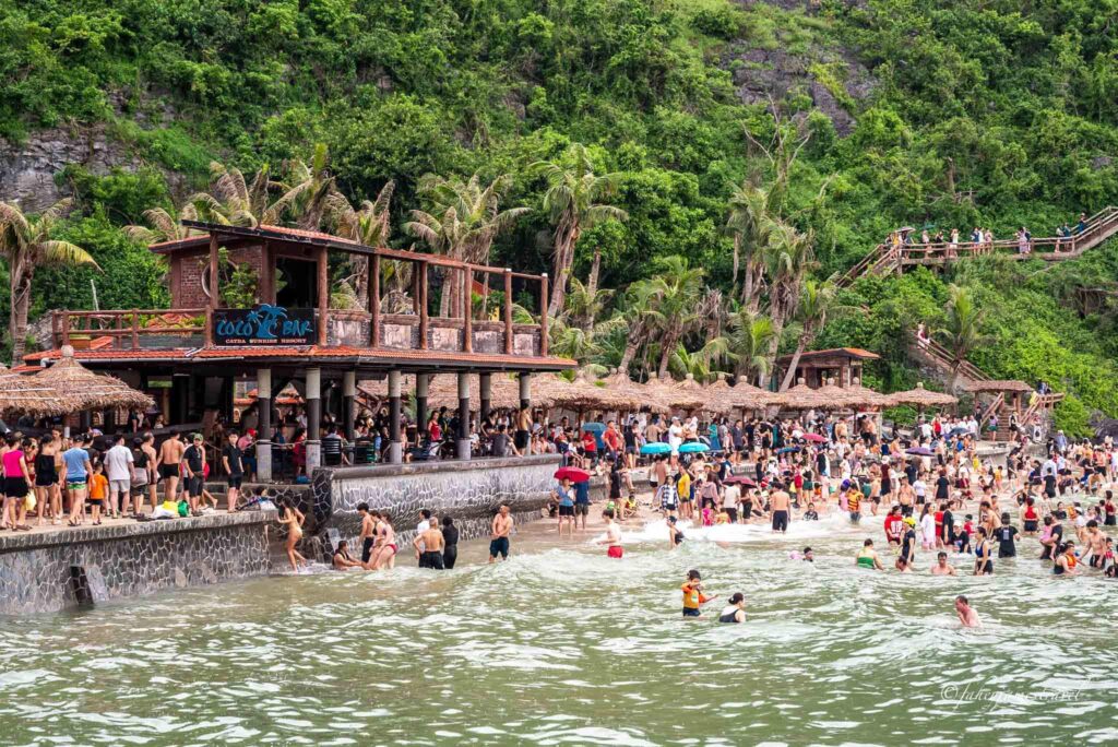 beaches of cat ba shows a lot of people swimming