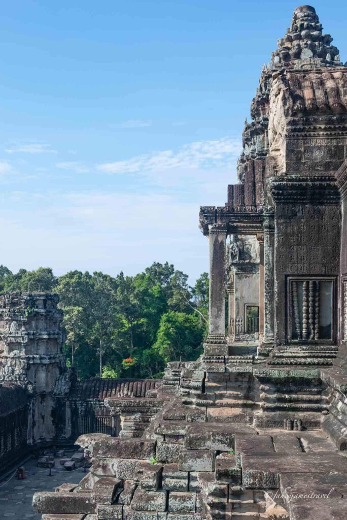 at the top of angkor wat shows stone and best way to visit is tuk tuk