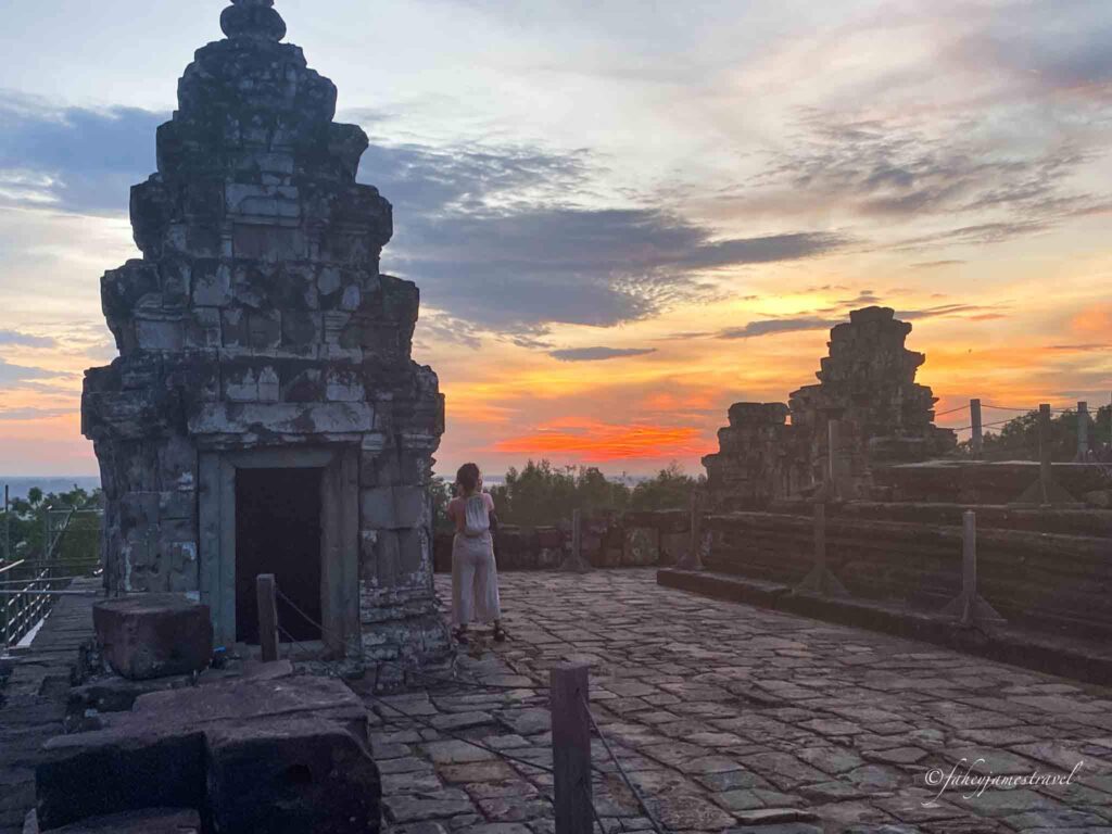sunset at angkor wat shows a red sky and temple